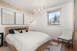 Queen-sized bed with plush linens. Your garden-level unit looks out at Red Mountain.