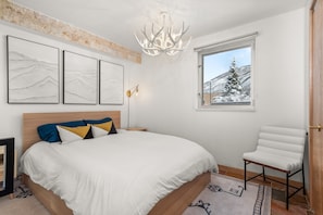 King-sized bed with plush linens. Your garden-level unit looks out at Red Mountain.