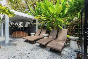 Exterior area with a relaxing seating space right next to the jacuzzi (1/2).