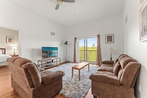 Living area with high ceilings, ample seating, and Smart TV