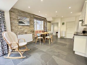 Rocking chair and dining table in kitchen of 36 High Street Holiday Cottage, Padstow, North Cornwall