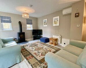 Log burner in living room of Stowaway Holiday Cottage, Padstow, North Cornwall
