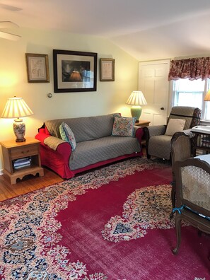 sunny/inviting living room is open to the dining area and kitchen. 