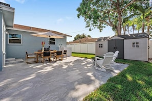 Saltwater swimming pool, deck, dining table, sitting area, grill, fire pit
