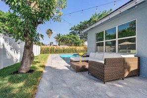 Saltwater swimming pool, deck, dining table, sitting area, grill, fire pit