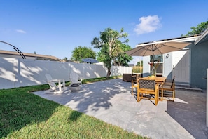 Saltwater swimming pool, deck, dining table, sitting area, grill, fire pit