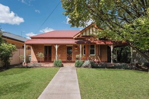 Step into timeless charm with this classic Federation brick home, nestled among manicured gardens, offering the perfect blend of urban comfort and country serenity.