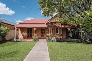 Step into timeless charm with this classic Federation brick home, nestled among manicured gardens, offering the perfect blend of urban comfort and country serenity.