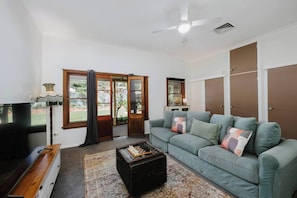 Retreat to the second living room, where a comfortable sofa, garden view, and TV set the scene for movie nights, board games, or simply relaxing after a day of wine tasting.
