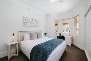 The second bedroom also offers a king bed and a dedicated workspace, blending comfort with convenience for a functional stay.
