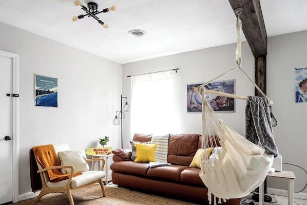 The living room is nice and cozy with the indoor swing!