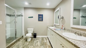 Spacious bathroom 1 with dual sinks and granite countertops.