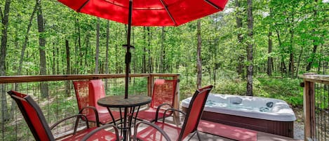 Beautiful deck with patio table and chairs….hot tub in background :)