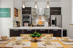 A modern and stylish dining area next to an open kitchen