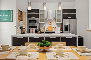 A modern and stylish dining area next to an open kitchen