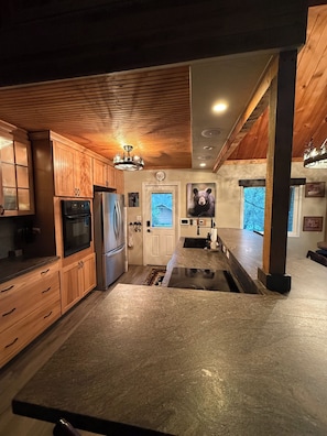 Fully equipped kitchen with bar seating for 8 and a small pub table for 3.