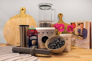 A fully equipped kitchen perfect for your cooking needs. Enjoy your favorite smoothies or protein shakes with premium Smeg blender. There are an assortment of cooking books to inspire your very own inner chef.