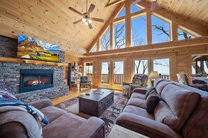 Stacked Stone Fireplace and a Wall of Windows in the Living Room