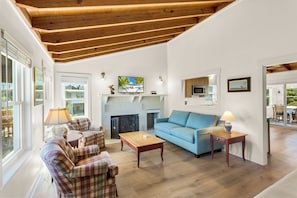 On the Main Level, the open-concept Living Area boasts a flat-screen TV and lots of cozy furniture.