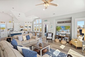 The spacious Living Area boasts high ceilings, a Smart TV, sound bar, and plenty of cozy furniture.