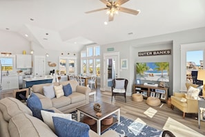 The spacious Living Area boasts high ceilings, a Smart TV, sound bar, and plenty of cozy furniture.