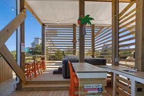 Outdoor living takes center stage with a 12' x 24' private pool, XL bubbly hot tub, and a lively tiki bar with a beverage fridge and sink create a backyard oasis.
