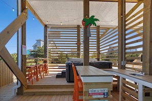 Outdoor living takes center stage with a 12' x 24' private pool, XL bubbly hot tub, and a lively tiki bar with a beverage fridge and sink create a backyard oasis.