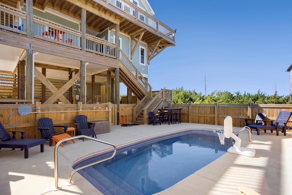 Outdoor living takes center stage with a 12' x 24' private pool, XL bubbly hot tub, and a lively tiki bar with a beverage fridge and sink create a backyard oasis.
