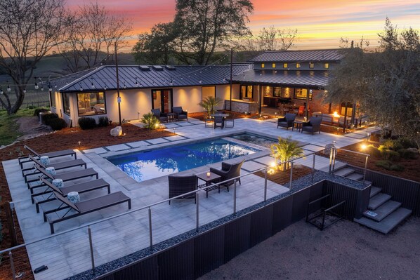 Take in the stunning elevated view of the pool area, complete with inviting loungers for the perfect day under the sun.