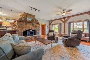 Spacious living room with cozy stone fireplace and natural light.
Has a queen pull out couch, also a futon twin sleeper chair
(Linens are in bedrom 1 closet)
