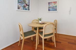 Enjoy your meals at the stylish round Scandinavian table, comfortably seating four in a bright and cosy space.