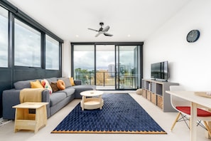 Feel at home in this inviting living room, where soft seating and a cosy atmosphere make it easy to unwind and relax.