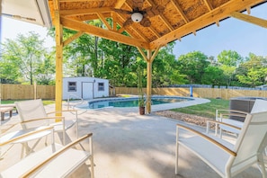 Embrace the outdoor life! This backyard is your personal paradise with a refreshing pool, sunny patio, and inviting lounge chairs. Ideal for enjoying the warm weather.