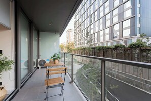 Enjoy a cozy balcony retreat with modern design, perfect for sipping coffee and taking in the city views.