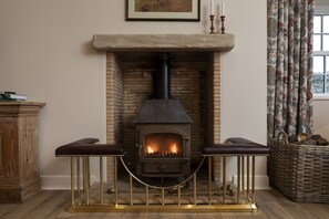 New Ladykirk Farmhouse - the log burner in the sitting room beside the kitchen