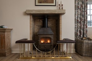 New Ladykirk Farmhouse - the log burner in the sitting room beside the kitchen