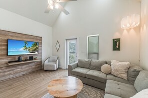 Unwind in comfort with plenty of room for the family in this open living room with flat-screen tv.