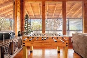 Mountain Memories 2's cozy living area foosball