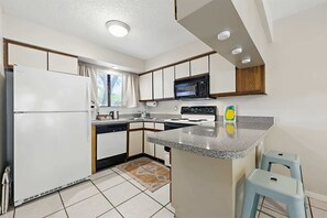 The open, airy kitchen offers ample space & every home comfort