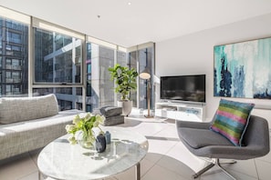 Step into the sunlit living area, where you can stretch out on the L-shaped sofa or wind down with your favourite TV shows.