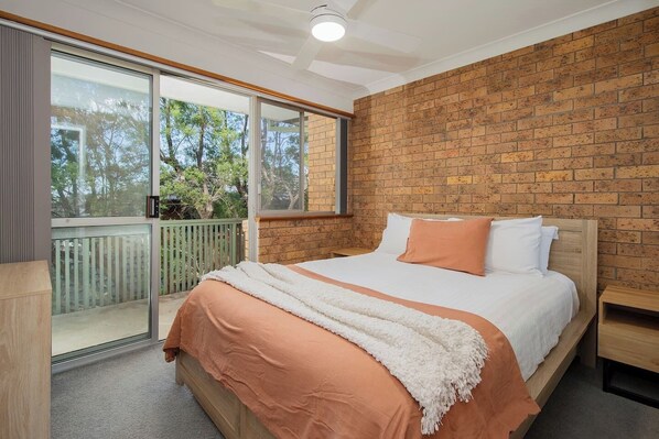 Wind down in the primary bedroom's queen bed with fresh linen, plus direct access to a small balcony for a quiet moment to yourself.