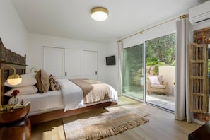 Bedroom with ample clothing storage and access to a private outdoor garden.