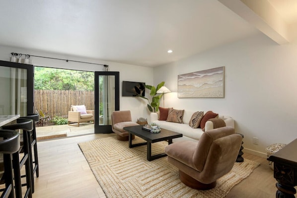 Living room opens up to your private garden allowing the warm sun and Mediterranean climate to enter your unit.