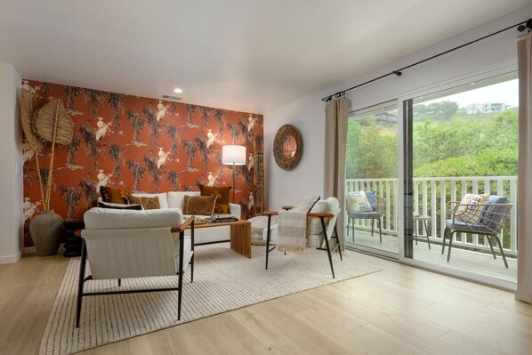 A chic accent wall that sets the perfect tone for your getaway. Living room also has direct access to your private balcony.