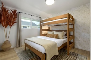 Bedroom featuring a stylish twin-over-queen bunk, perfect for a family retreat.