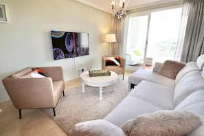 Step into a sunlit living room designed for comfort and connection, where modern style meets cozy charm and every window frames a view worth pausing for
