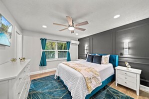 Bedroom Retreat: Vibrant green walls and plush bedding create a tranquil escape in paradise!
