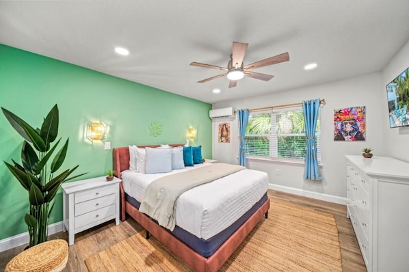 Bedroom Suite 1 with Queen Bed and Dresser Space: Vibrant green walls and plush bedding create a tranquil escape in paradise!