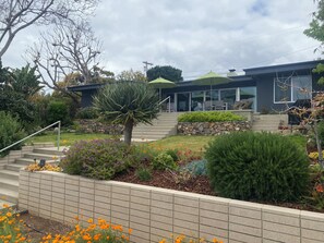 Backyard faces west catching ocean breezes and with views of ocean horizon