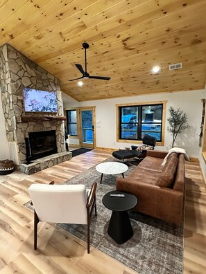 Family Room with smart Frame TV and wood burning fire place